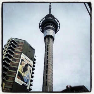 Sky Tower with high rise block next to it with huge poster advertising Downton Abbey